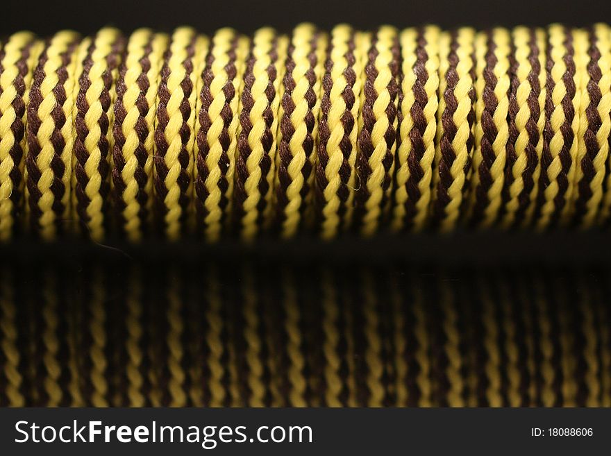 Closeup of a shoelace wrapped around a stick.