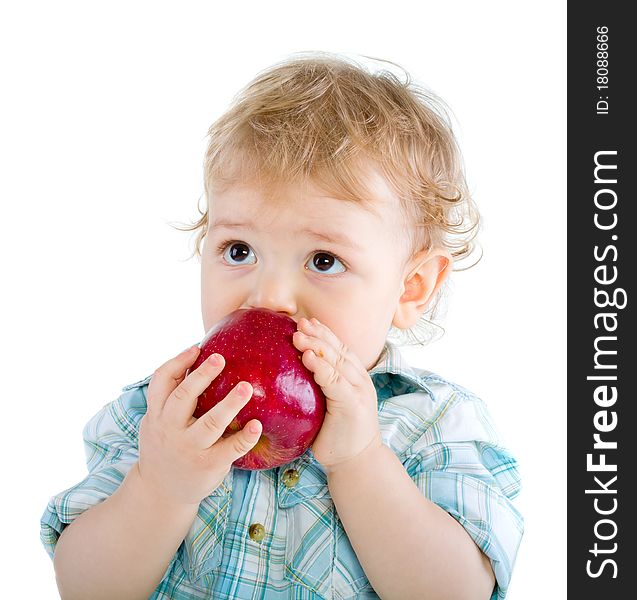 Beautiful baby boy eats red apple. Closeup portrait. Isolated.