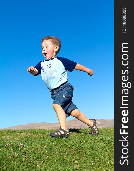 Little boy in fast move, park blue sky. Little boy in fast move, park blue sky