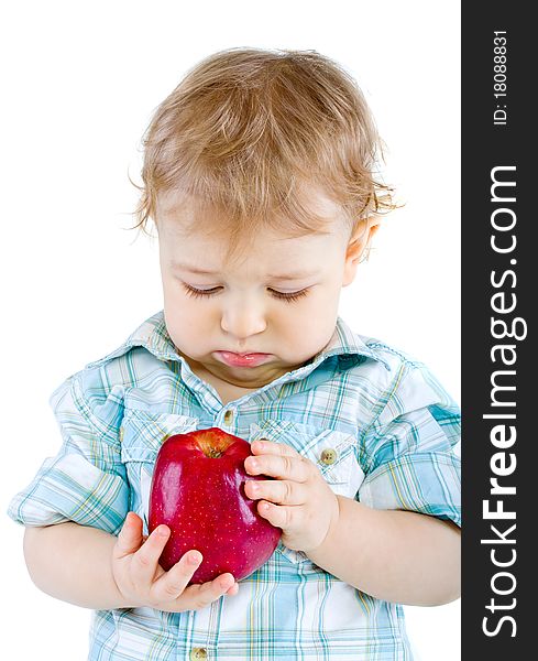 Beautiful baby boy eats red apple. Closeup portrait. Isolated.