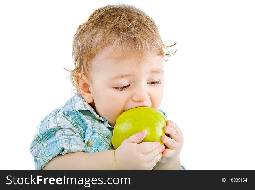 Beautiful baby boy eats green apple. Closeup portrait. Isolated.