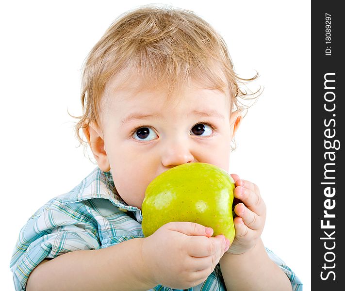 Beautiful baby boy eats green apple. Closeup portrait. Isolated.