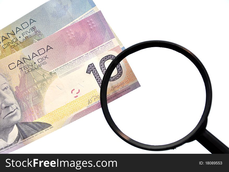 Magnifying glass on money background