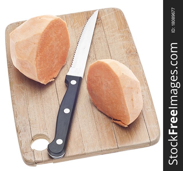 Sliced Sweet Potatoes on a Wooden Chopping Block Isolated on White with a Clipping Path.