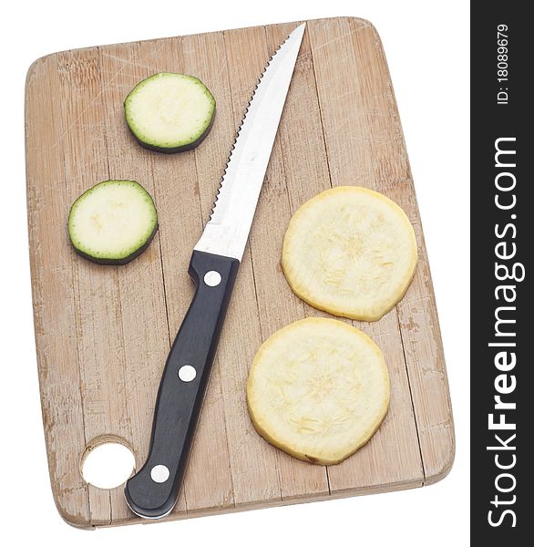 Sliced Yellow Squash on a Wooden Chopping Block Isolated on White with a Clipping Path.