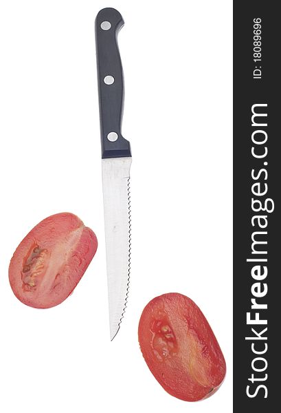 Sliced Roma Tomato with Knife Isolated on White with a Clipping Path.