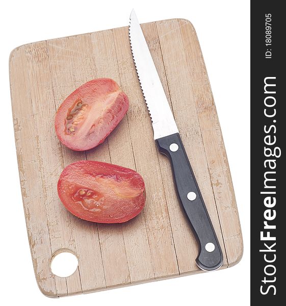 Sliced Roma Tomato on a Wooden Chopping Block Isolated on White with a Clipping Path.