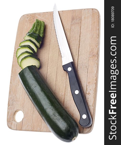 Sliced Zucchini on a Wooden Chopping Block Isolated on White with a Clipping Path.