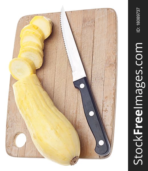 Sliced Yellow Squash on a Wooden Chopping Block Isolated on White with a Clipping Path.