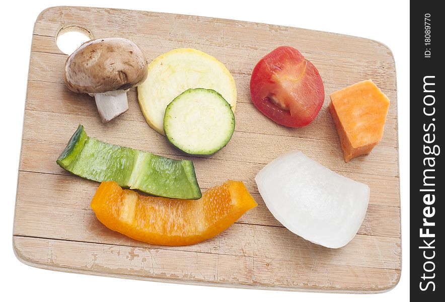 Variety of Vegetables Mushroom, Pepper, Onion, Tomato, and Sweet Potato on a Wooden Chopping Block.