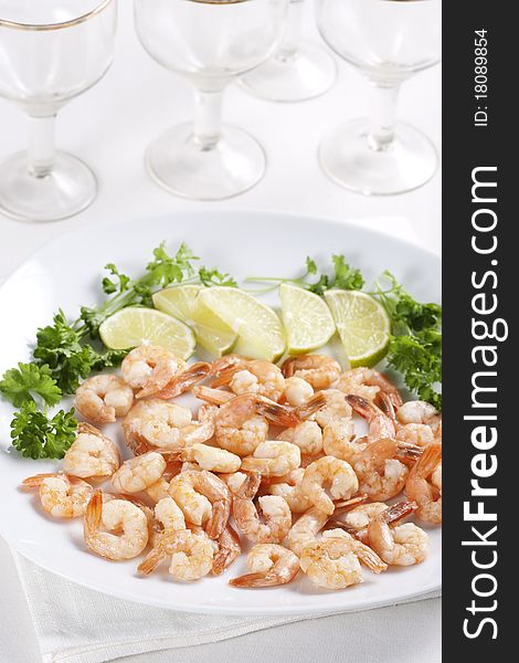 Shrimps on a plate with lime and parsley. Shrimps on a plate with lime and parsley