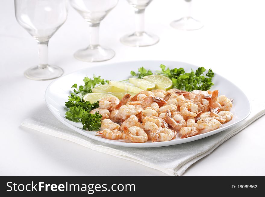 Shrimps on a plate with lime and parsley. Shrimps on a plate with lime and parsley