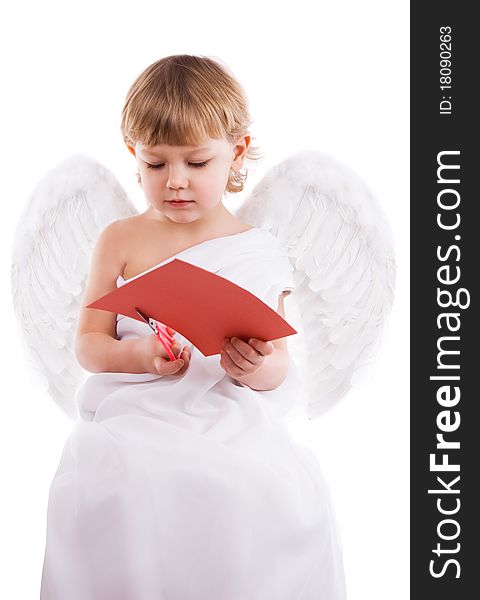 Boy angel with wings cut with scissors from red cardboard heart. Boy angel with wings cut with scissors from red cardboard heart