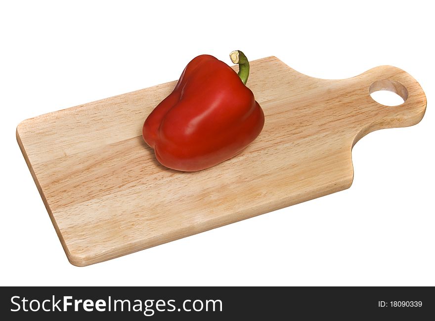 Fresh red pepper is on the board for cutting vegetables. Fresh red pepper is on the board for cutting vegetables