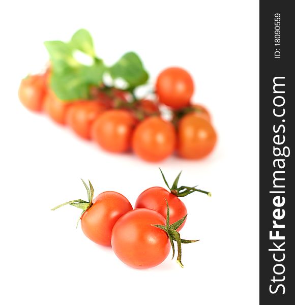 Three tomatoes-cherry on a white background