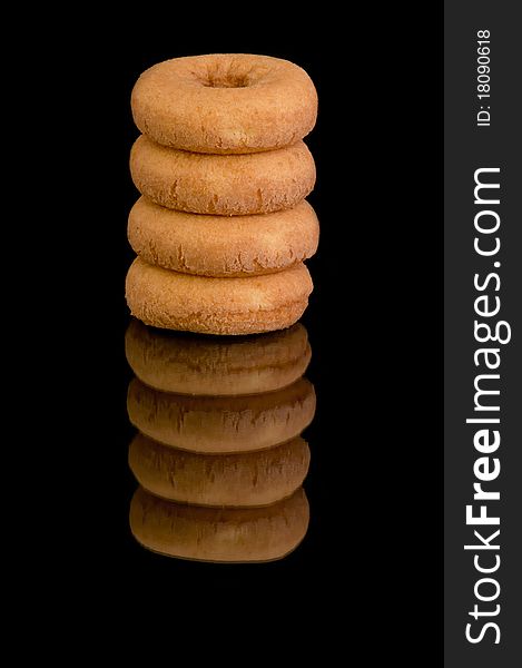 Tower of donuts on black background.