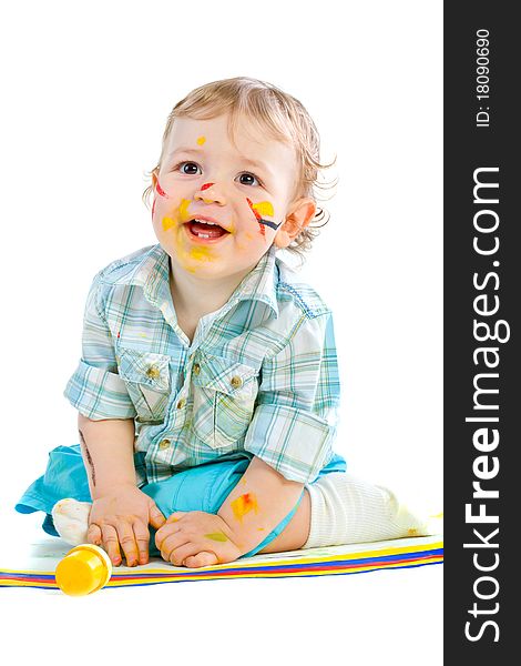 Beautiful baby covered in bright paint with paint brush.  Isolated.