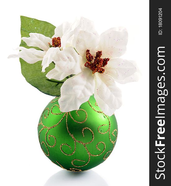 White poinsettias in a green Christmas bulb with sparkly gold swirls. Isolated on white. White poinsettias in a green Christmas bulb with sparkly gold swirls. Isolated on white.