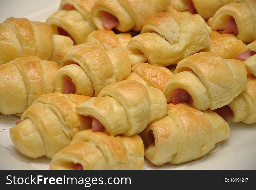 Pile of sausage rolls on a plate. Pile of sausage rolls on a plate