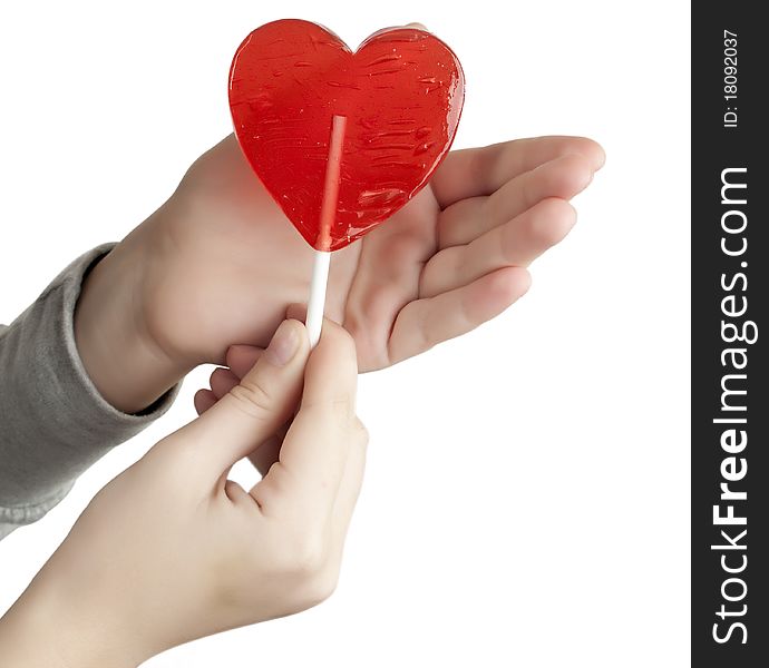 Candy red heart in the hands of a white background