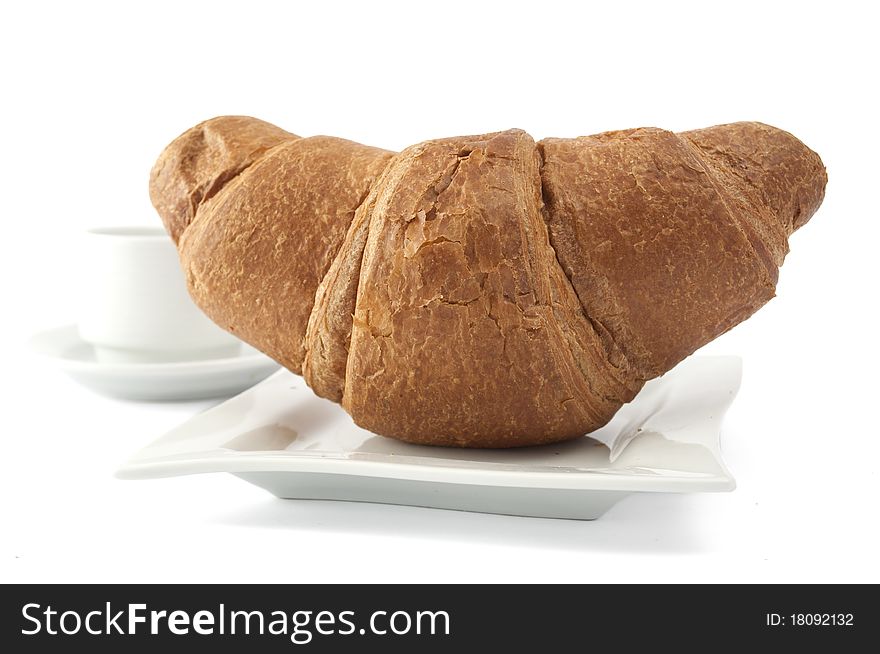 Croissant on a white plate on white background