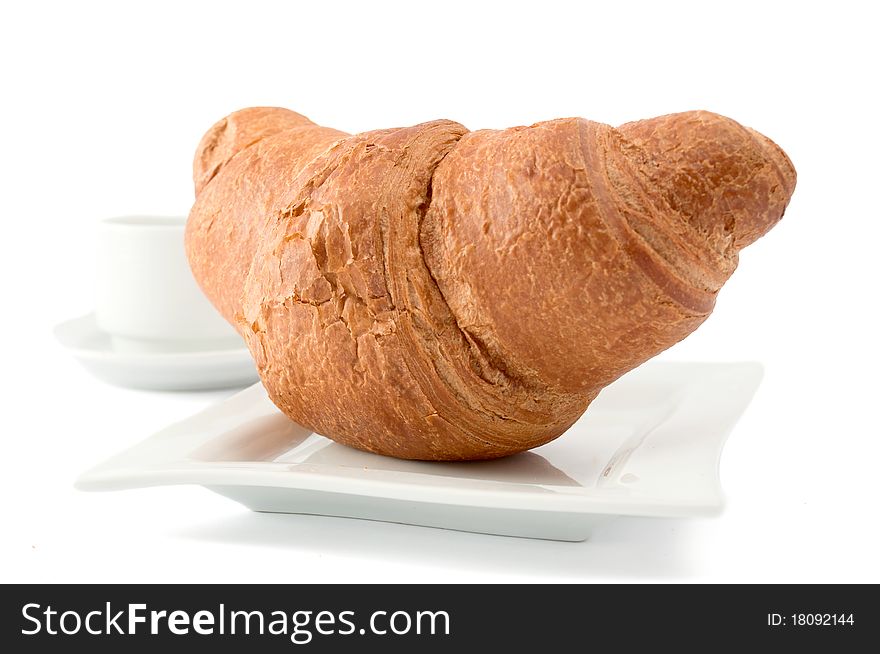 Croissant on a white plate on white background