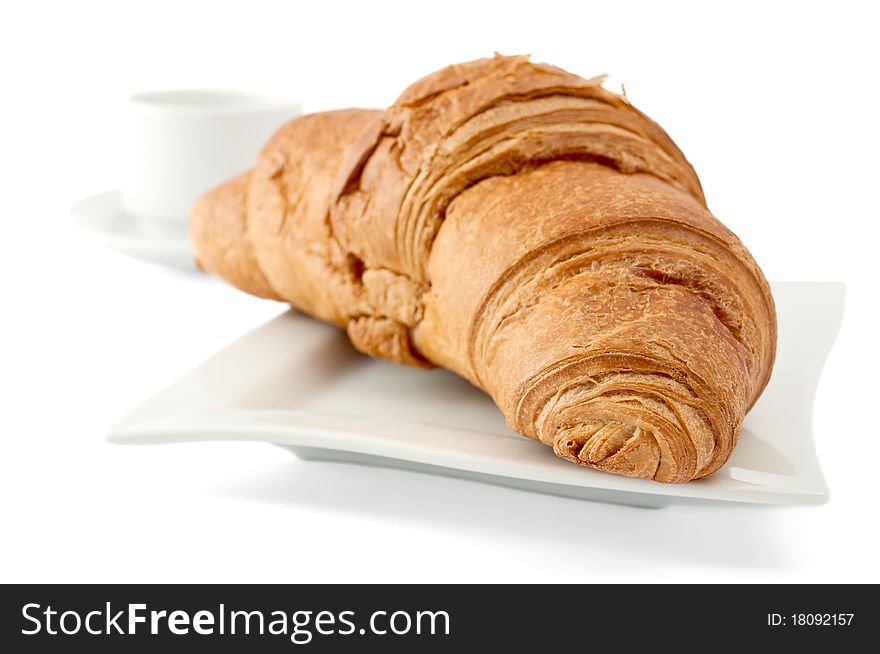 Croissant on a white plate on white background