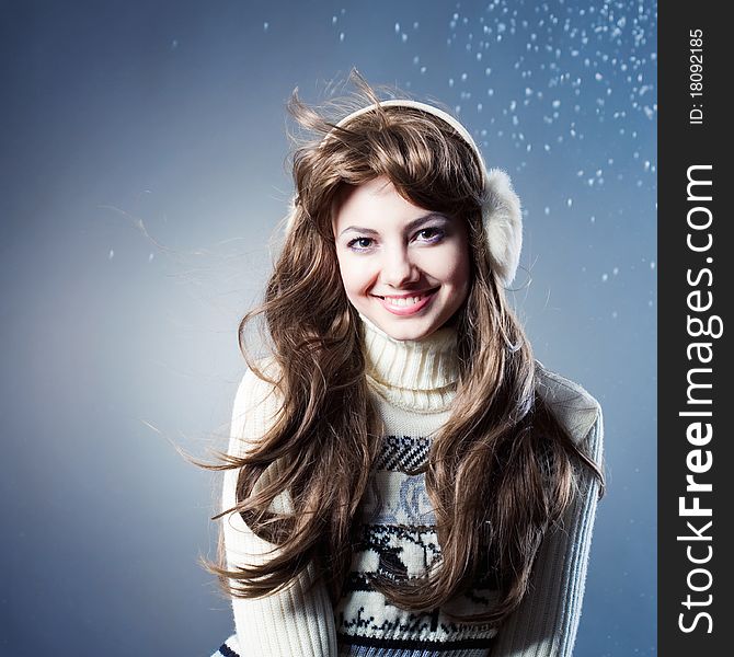 Young beautiful girl rejoices to snow, On a dark blue background