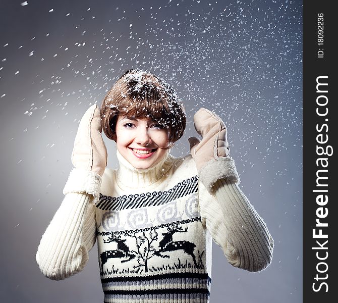 Young beautiful girl rejoices to snow, On a dark blue background