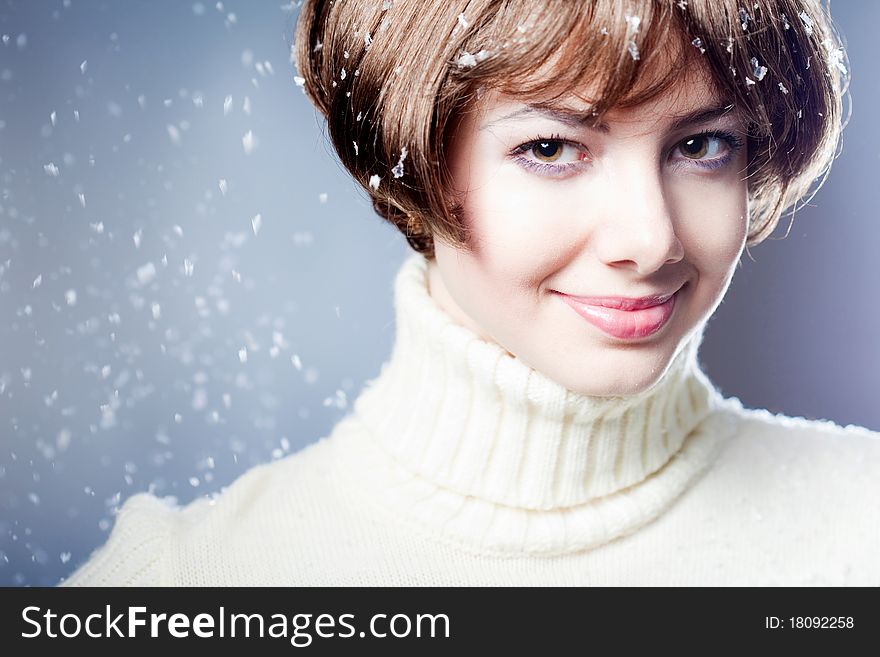 Young beautiful girl rejoices to snow, On a dark blue background