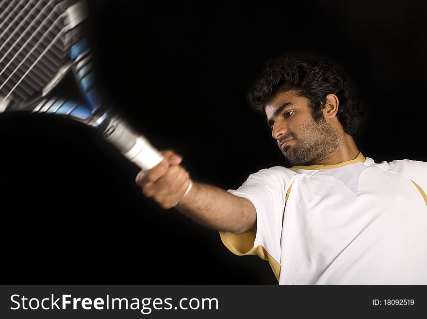 Tennis player playing a fore hand shot.