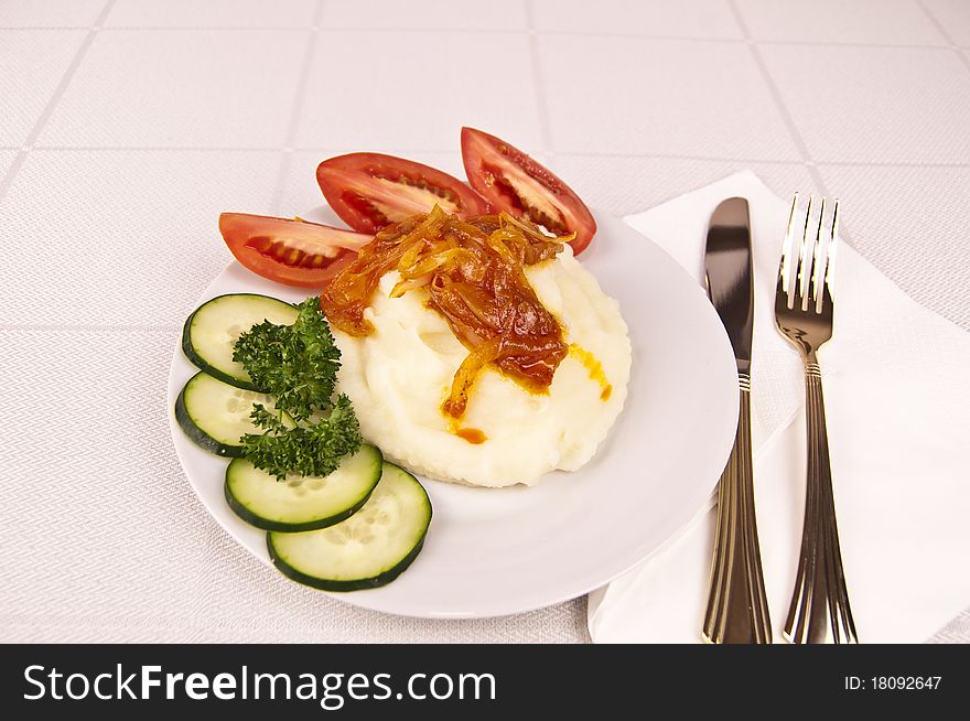 Mashed potatoes with vegetables and sause on a table