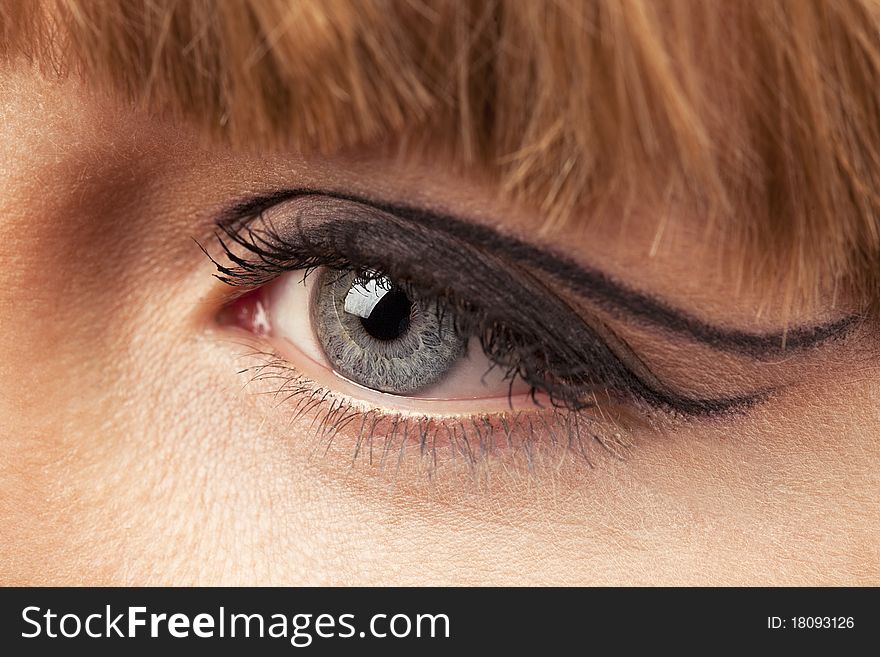 Close-up of woman eye with ceremonial bright make-up