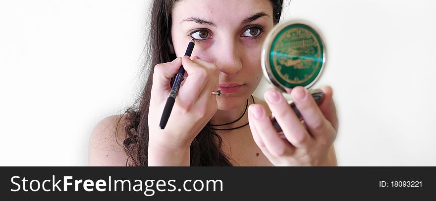 Teenager applying mascara and makeup. Teenager applying mascara and makeup