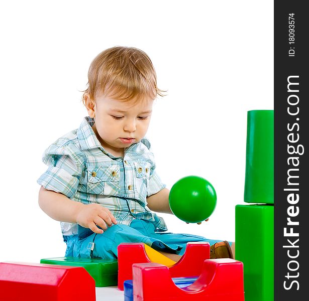 Cute little baby boy with colorful building blocks isolated on white