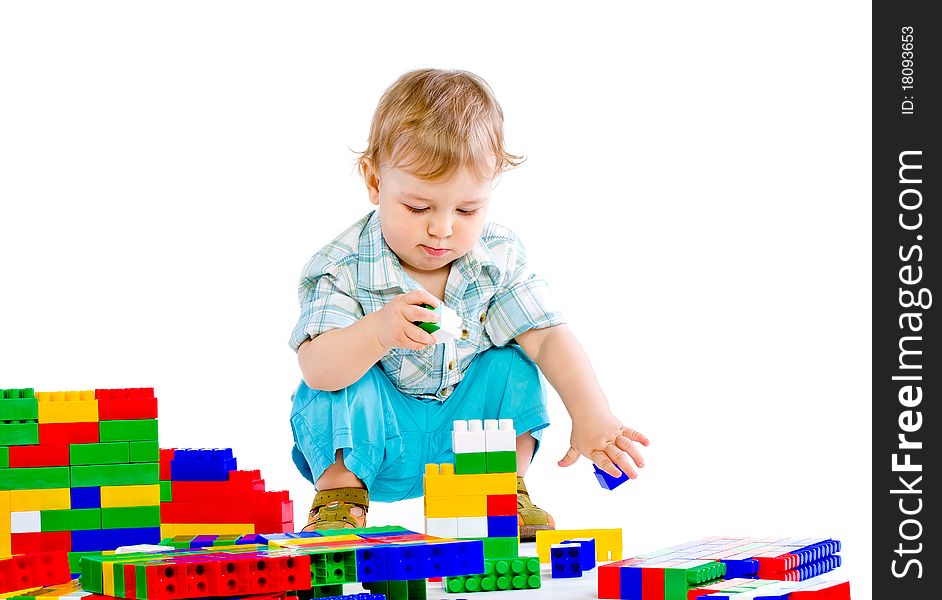 Cute little baby boy with colorful building blocks isolated on white