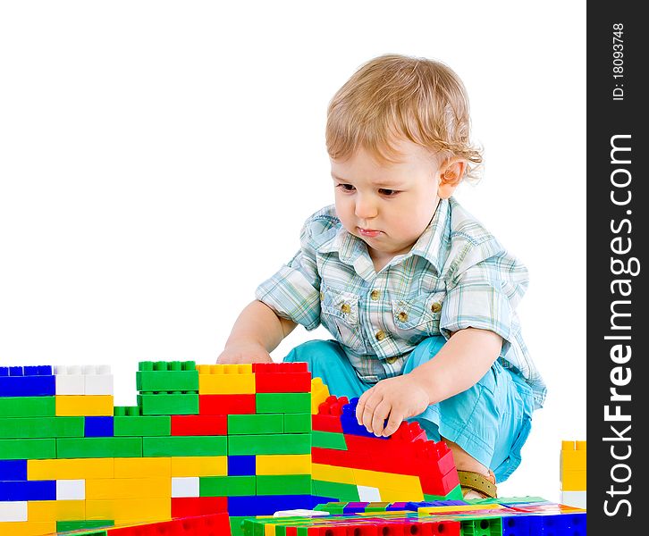 Cute little baby boy with colorful building blocks isolated on white
