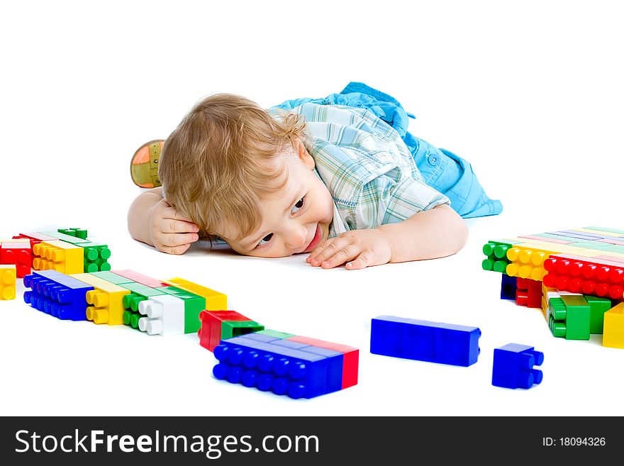 Cute little baby boy with colorful building blocks isolated on white