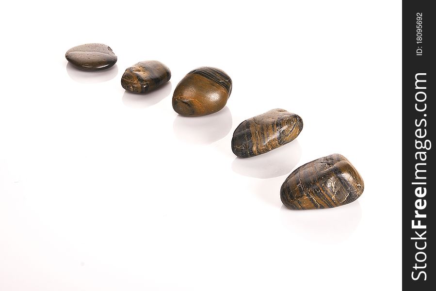 FIVE BROWN STONES  in a curved line. FIVE BROWN STONES  in a curved line
