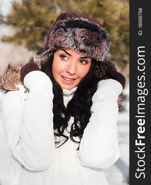 A young beautiful girl on a walk in a winter park, winter, snow, forest.