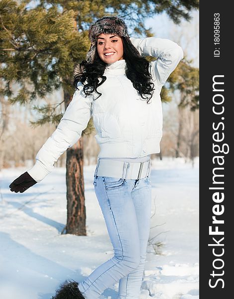 A young beautiful girl on a walk in a winter park, winter, snow, forest.