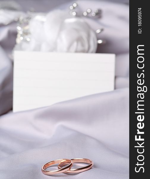 Wedding rings on gray silk