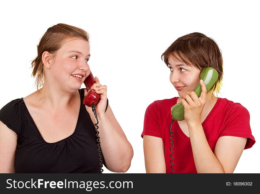 Two young women telephoning - isolated. Two young women telephoning - isolated