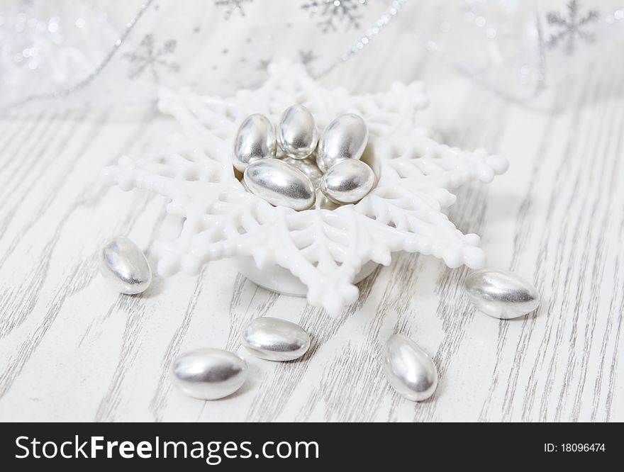 Silver Pistachio Candy on the white wooden background