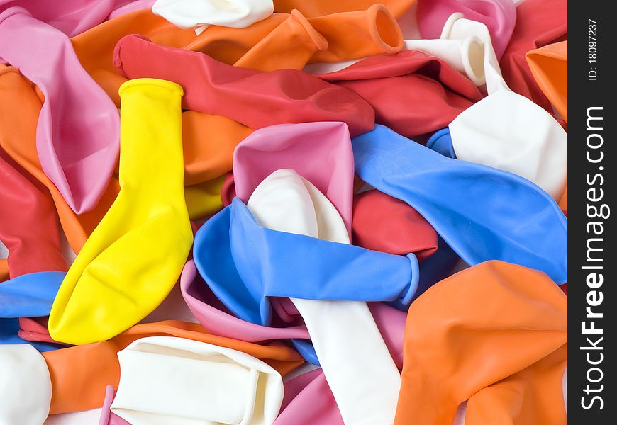 A lot of yellow, blue, red, orange, pink and white latex uninflating balloons