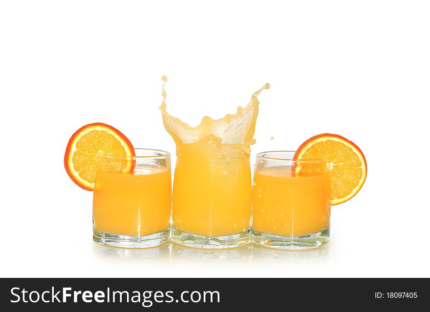 Three glasses of orange juice and fruits isolated on white background with clipping path. Three glasses of orange juice and fruits isolated on white background with clipping path
