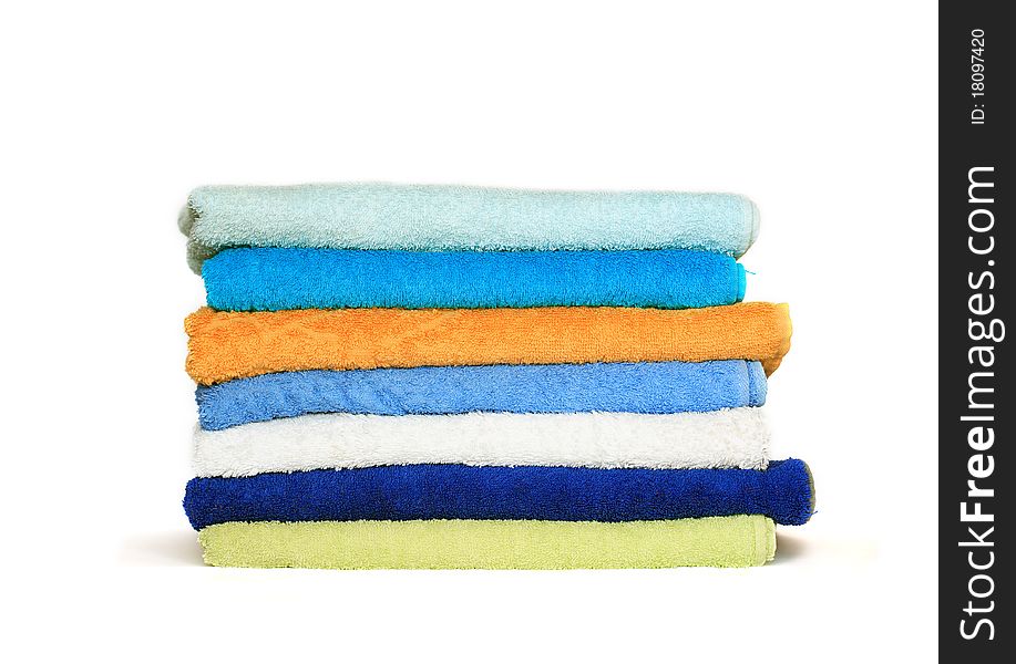 Stack of clean colorful towels isolated on white background. Stack of clean colorful towels isolated on white background