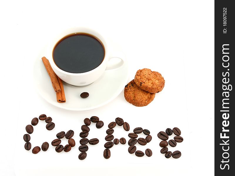 White coffee cup with cinamon sticks, cookies and a text written with coffee beans. White coffee cup with cinamon sticks, cookies and a text written with coffee beans