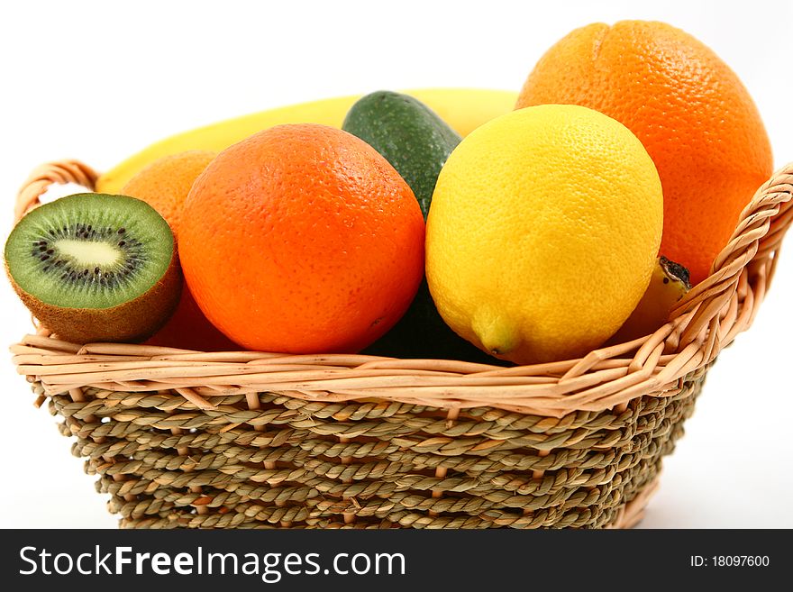 A basket full of exotic fruits - closeup - isolated on white. A basket full of exotic fruits - closeup - isolated on white