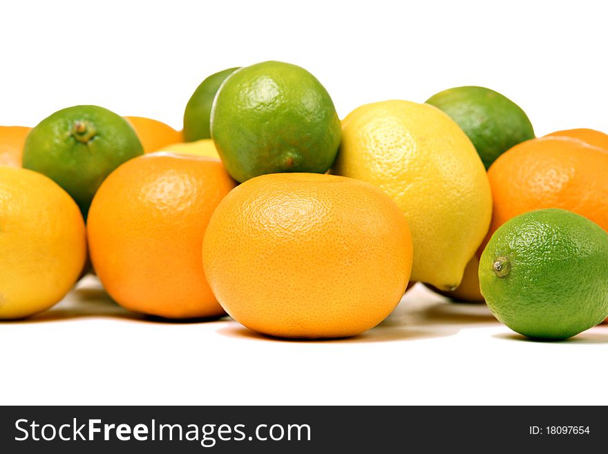 Whole oranges, lemons and limes, isolated on white